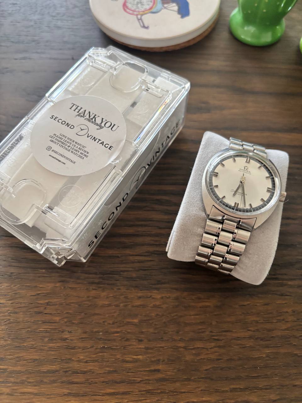 Vintage Omega Seamaster on a cushion beside its Second Vintage travel case
