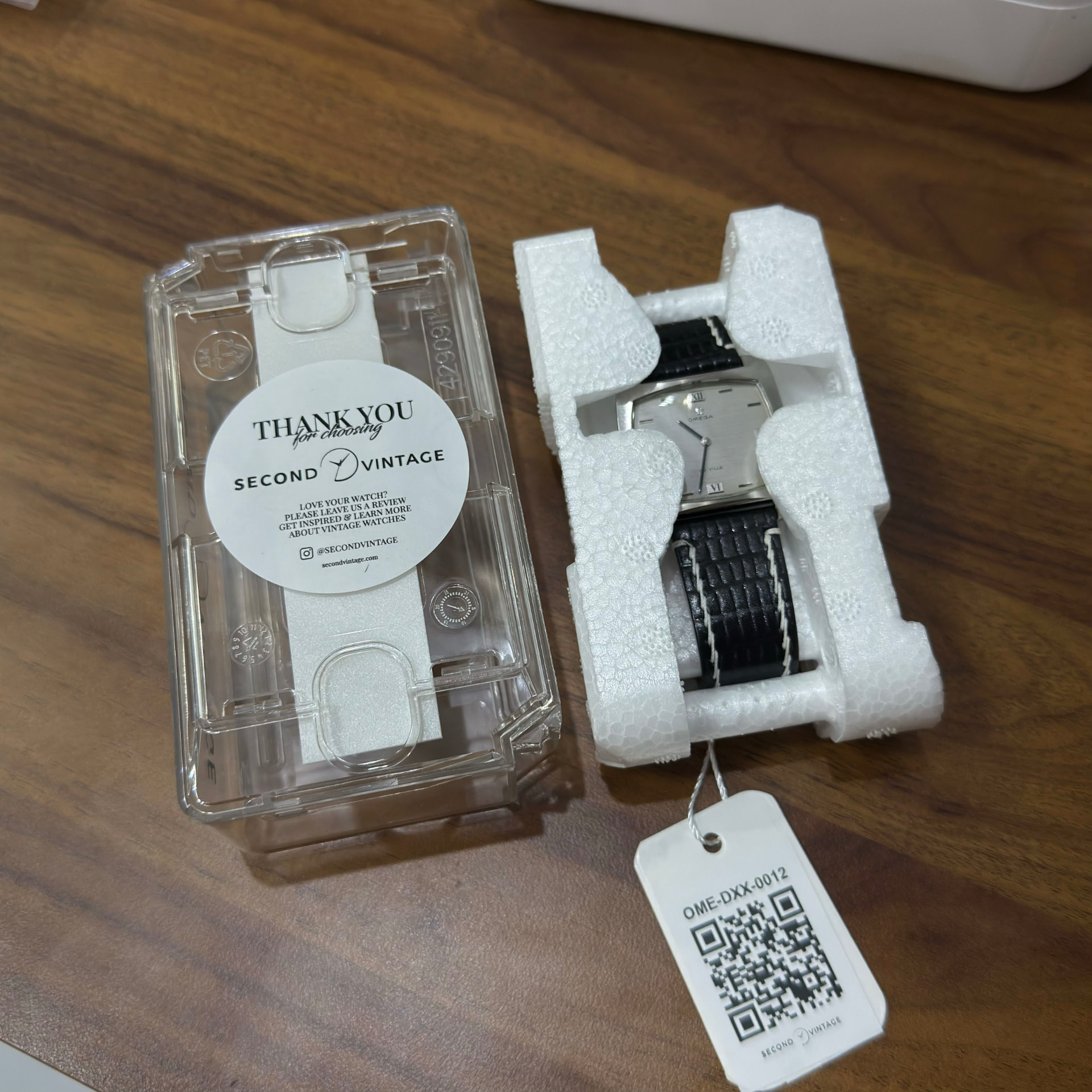 Vintage Omega De Ville with its Second Vintage QR tag next to the thank-you sticker case