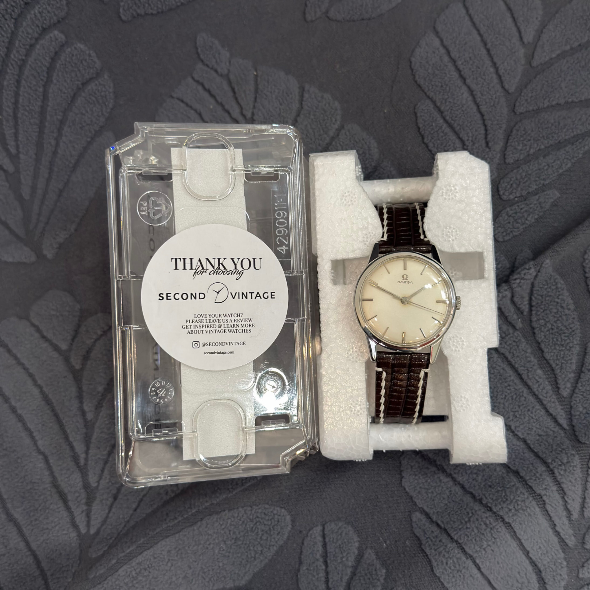 Vintage Omega on a brown strap packed beside the Second Vintage thank-you card
