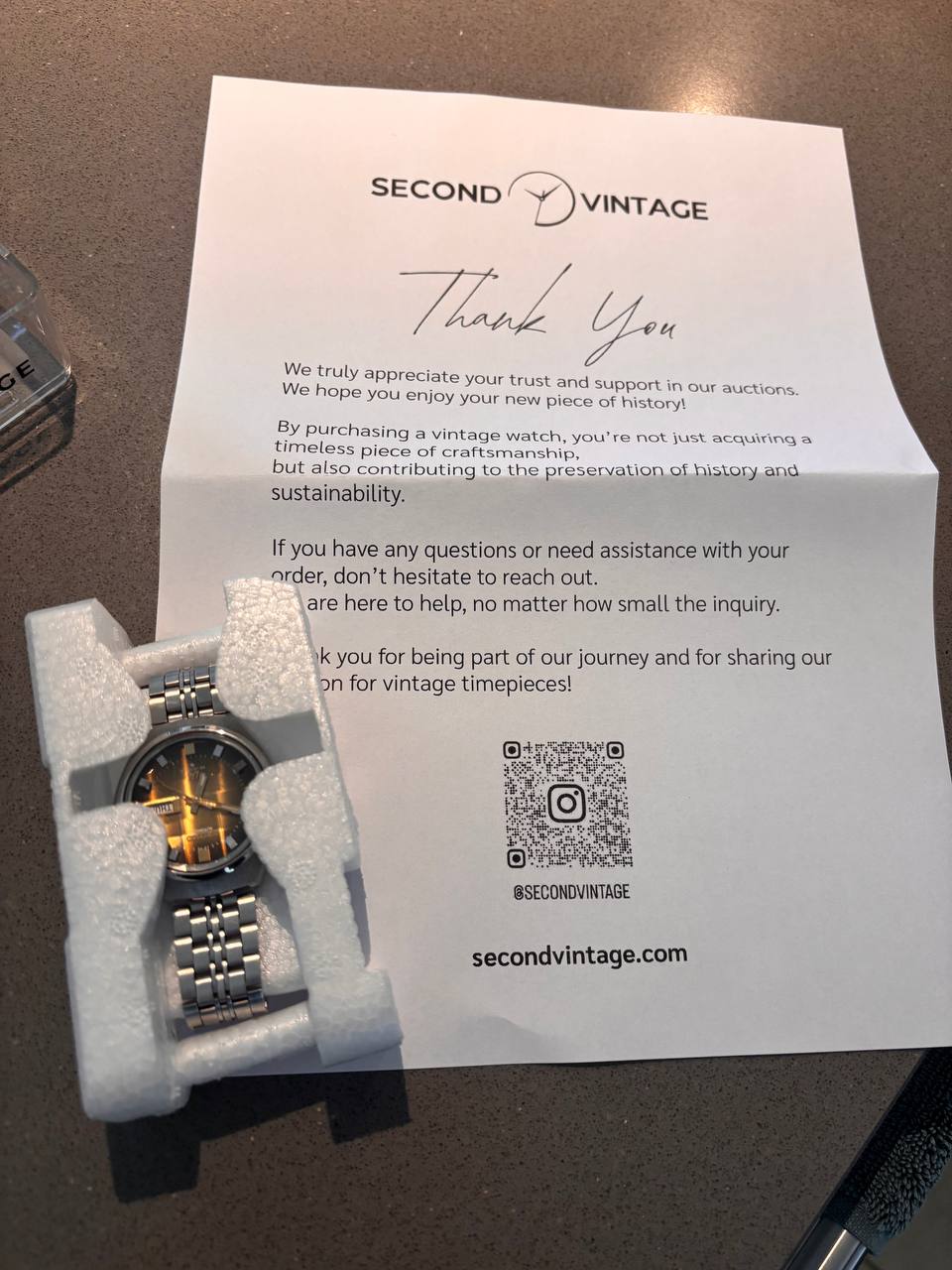 Thank-you letter and a vintage watch packed for shipping by Second Vintage