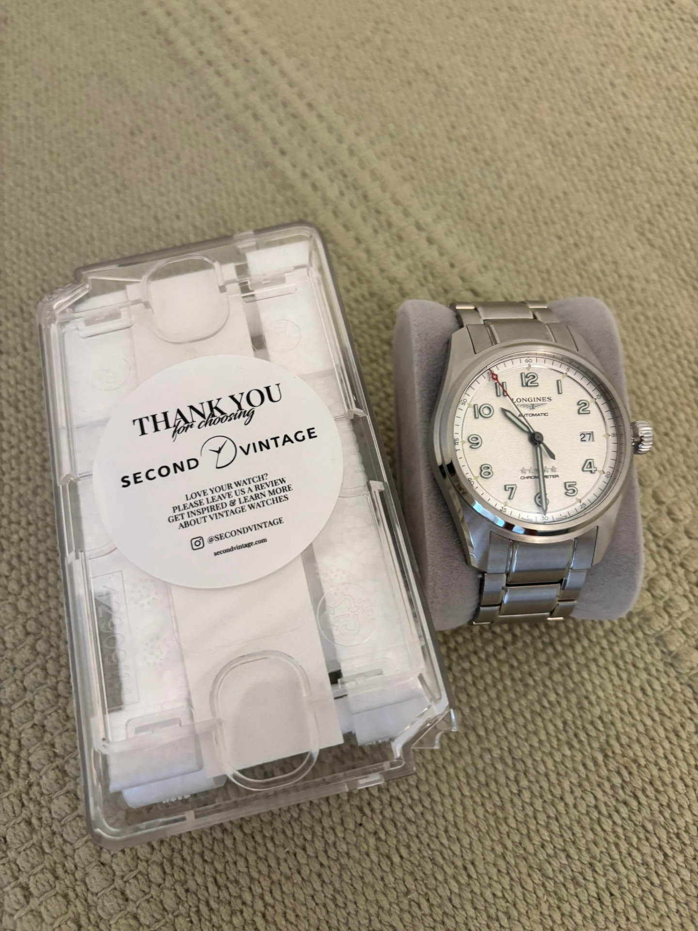 Longines Spirit chronometer on a cushion beside its Second Vintage case