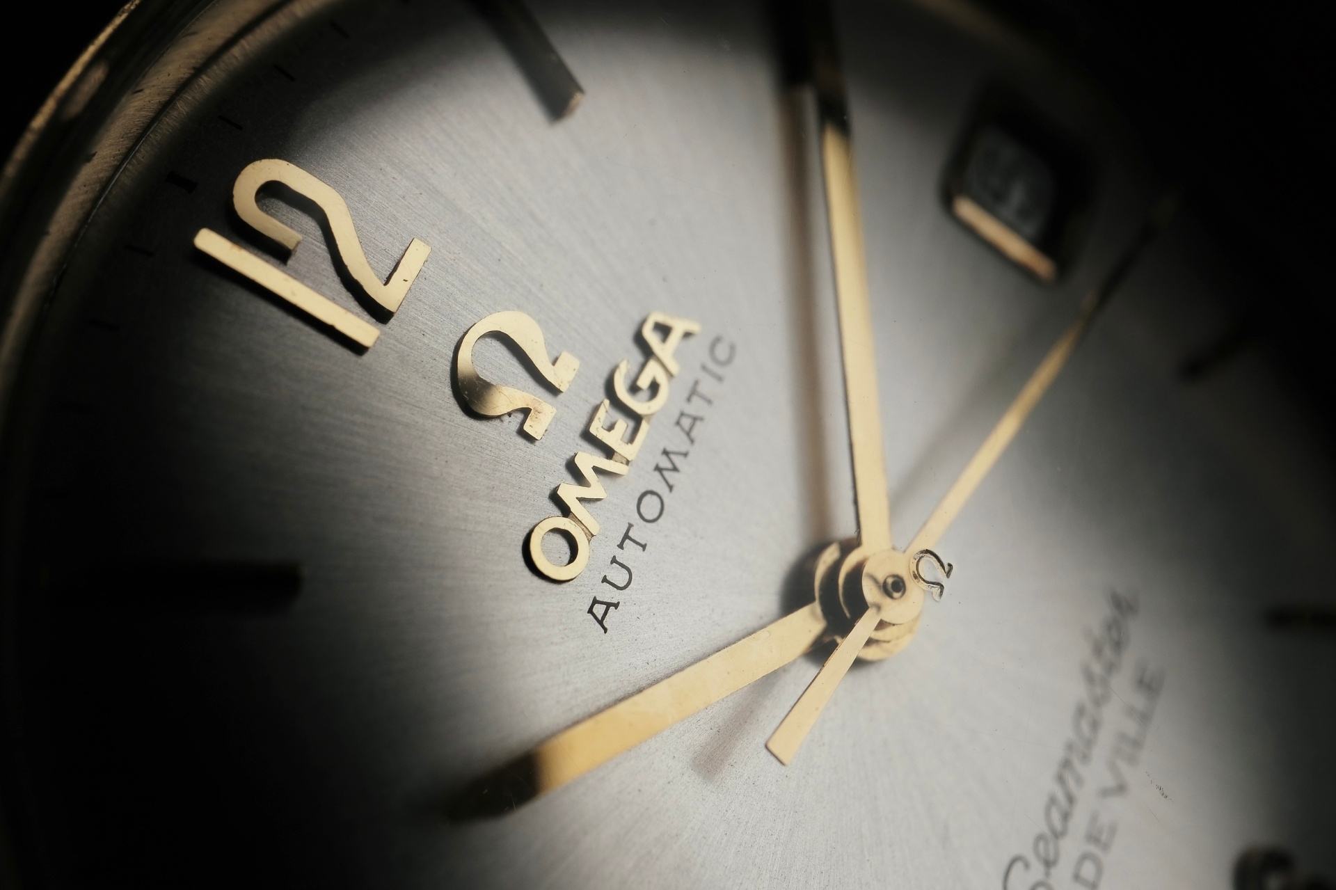 Omega Seamaster De Ville dial closeup showing applied logo and indices