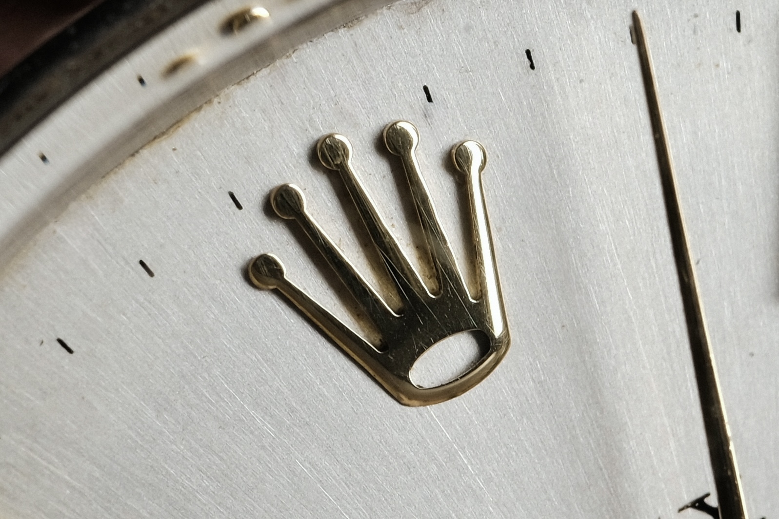 Rolex applied crown logo showing authentic finishing details